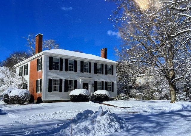 colonial home featuring a chimney