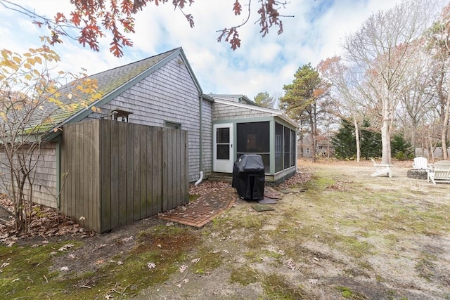 view of side of home with a sunroom