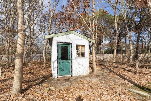 view of shed featuring fence