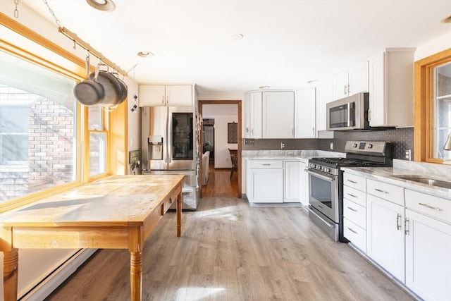 kitchen featuring light stone countertops, white cabinetry, and stainless steel appliances