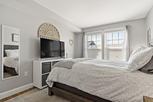 bedroom featuring baseboards and wood finished floors