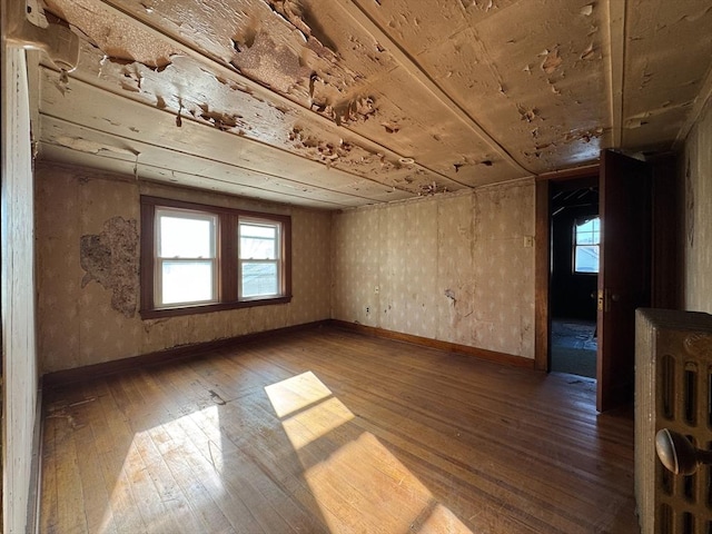 spare room with hardwood / wood-style floors, wood ceiling, and a wealth of natural light