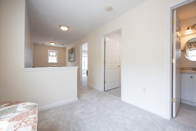 140 Commonwealth Ave Unit 38, North Attleboro, MA 02763 - unfurnished bedroom with light carpet, a sink, and baseboards