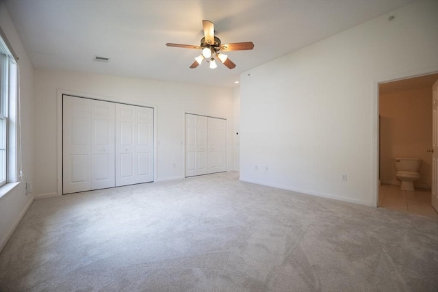 140 Commonwealth Ave Unit 38, North Attleboro, MA 02763 - unfurnished bedroom with two closets, light colored carpet, baseboards, ensuite bathroom, and ceiling fan