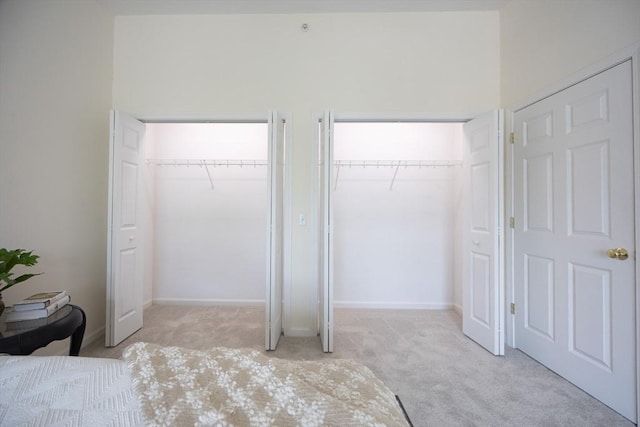 140 Commonwealth Ave Unit 38, North Attleboro, MA 02763 - unfurnished bedroom with two closets, light colored carpet, and baseboards