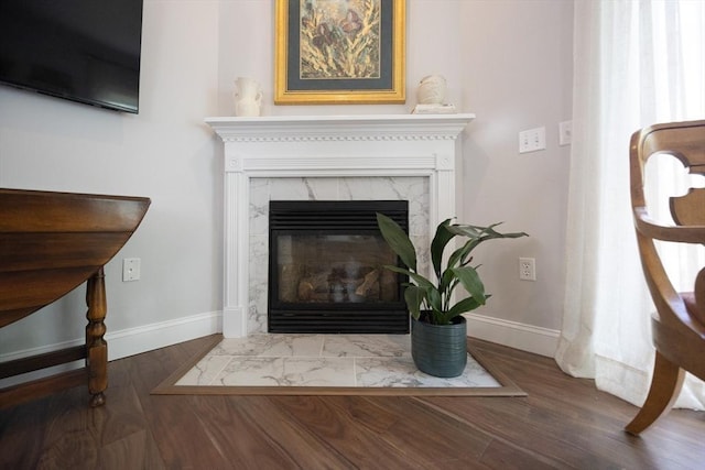 140 Commonwealth Ave Unit 38, North Attleboro, MA 02763 - detailed view of baseboards, a fireplace, and wood finished floors