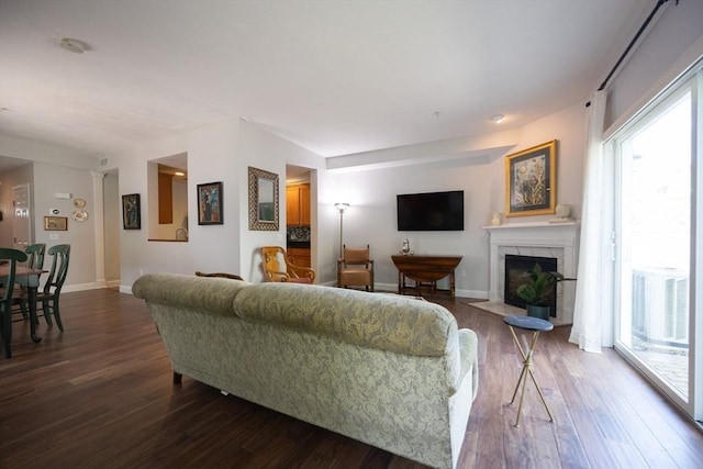 140 Commonwealth Ave Unit 38, North Attleboro, MA 02763 - living area featuring dark wood finished floors, a fireplace with flush hearth, and baseboards
