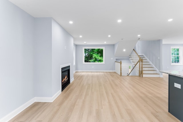 unfurnished living room featuring light wood-type flooring