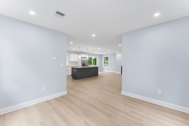 unfurnished living room with light hardwood / wood-style flooring