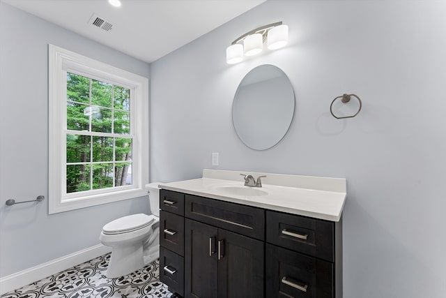 bathroom featuring tile patterned floors, toilet, and vanity