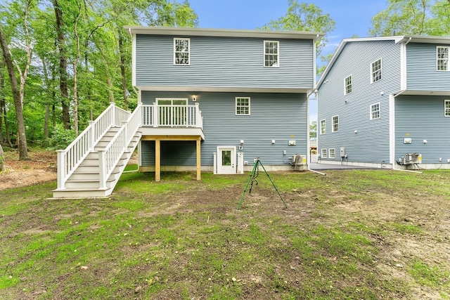 back of house with a yard and a wooden deck