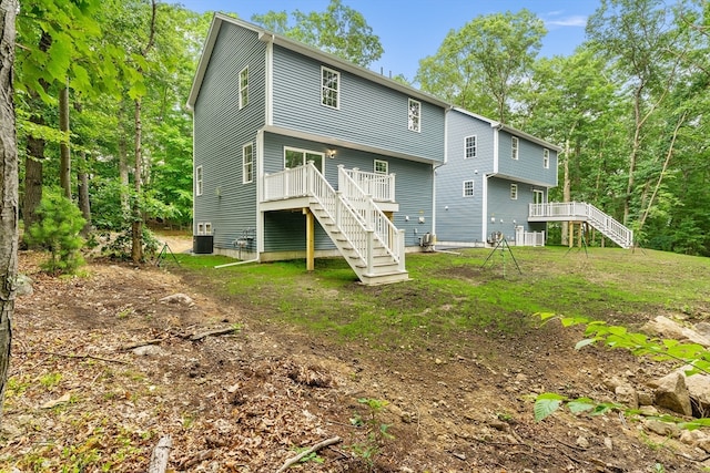 back of house featuring a deck and cooling unit