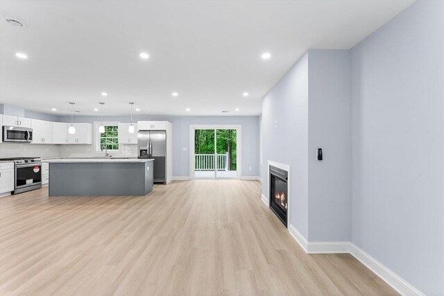 unfurnished living room featuring light hardwood / wood-style floors