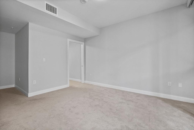 unfurnished room featuring light carpet, visible vents, and baseboards