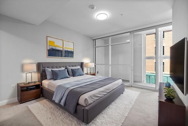 bedroom featuring light colored carpet, baseboards, and multiple windows