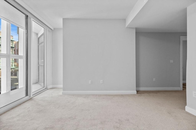 carpeted spare room with baseboards