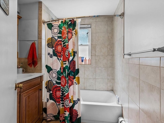 bathroom featuring shower / bathtub combination with curtain and vanity