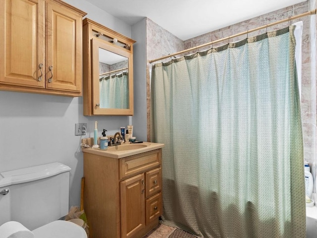 bathroom featuring vanity, shower / bath combo, and toilet