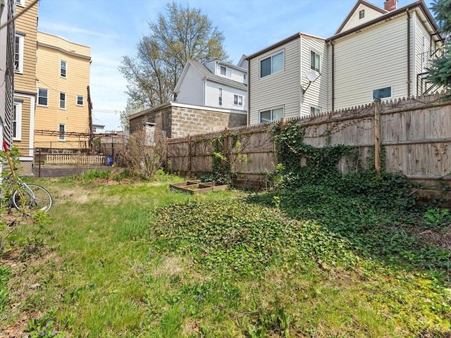 view of yard featuring a fenced backyard and a garden