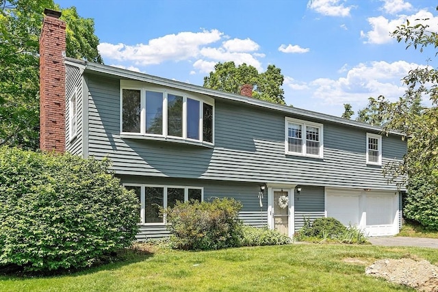 15 Greenbrook Rd, Hamilton, MA 01982 - view of front facade with a chimney, a garage, a front lawn, and driveway
