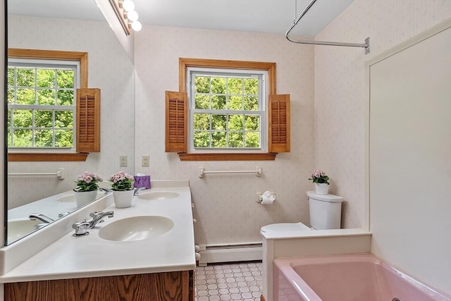 15 Greenbrook Rd, Hamilton, MA 01982 - bathroom with a baseboard radiator, wallpapered walls, a tub to relax in, and double vanity