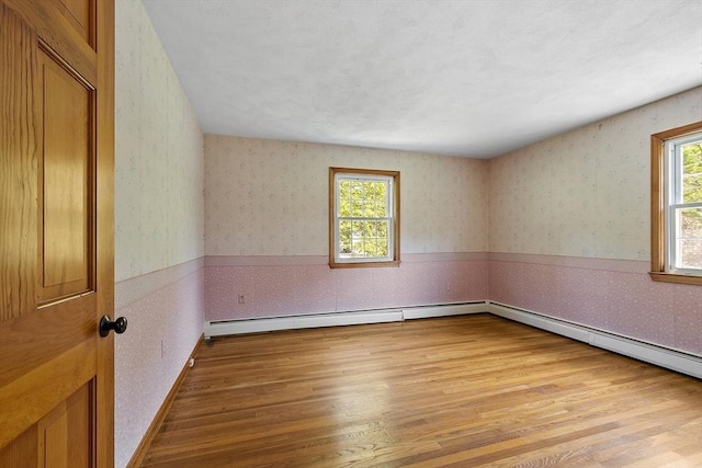 15 Greenbrook Rd, Hamilton, MA 01982 - spare room with wallpapered walls, light wood-type flooring, and a baseboard radiator