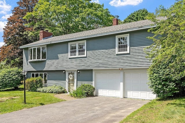 15 Greenbrook Rd, Hamilton, MA 01982 - colonial-style house featuring a garage, a chimney, a front lawn, and driveway