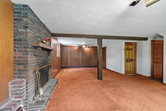 15 Greenbrook Rd, Hamilton, MA 01982 - unfurnished living room featuring a brick fireplace, light colored carpet, a textured ceiling, and wood walls