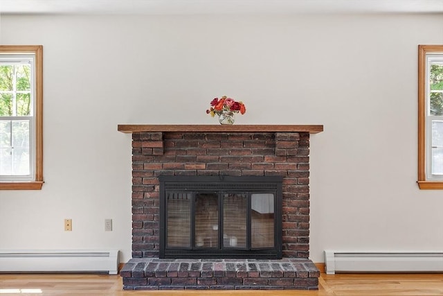 15 Greenbrook Rd, Hamilton, MA 01982 - detailed view of a baseboard heating unit, a fireplace, and wood finished floors
