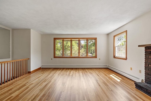 15 Greenbrook Rd, Hamilton, MA 01982 - unfurnished living room featuring a baseboard radiator, healthy amount of natural light, and wood finished floors