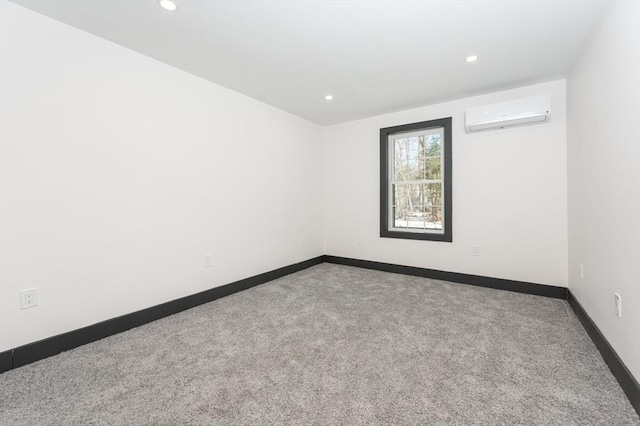 carpeted empty room featuring a wall mounted AC