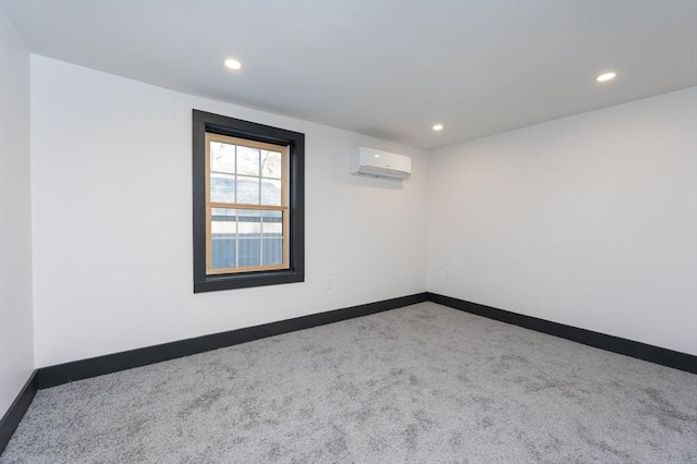 carpeted spare room with an AC wall unit