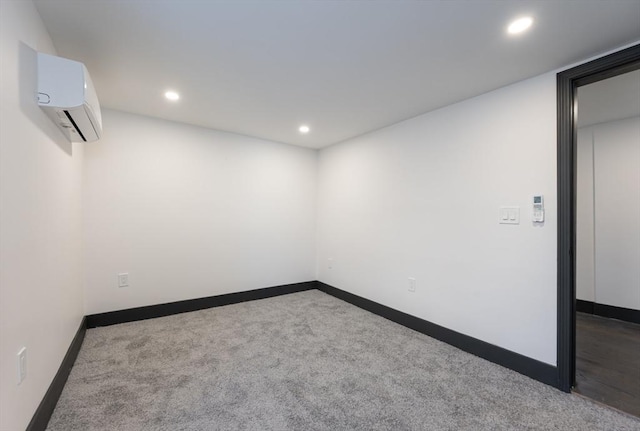 carpeted empty room featuring a wall unit AC