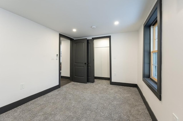 unfurnished bedroom featuring light colored carpet