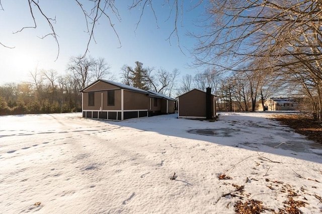 view of snow covered rear of property