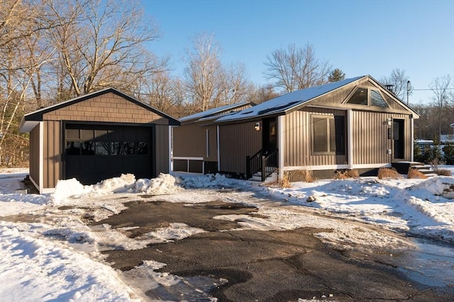 view of front of property featuring a garage and an outdoor structure