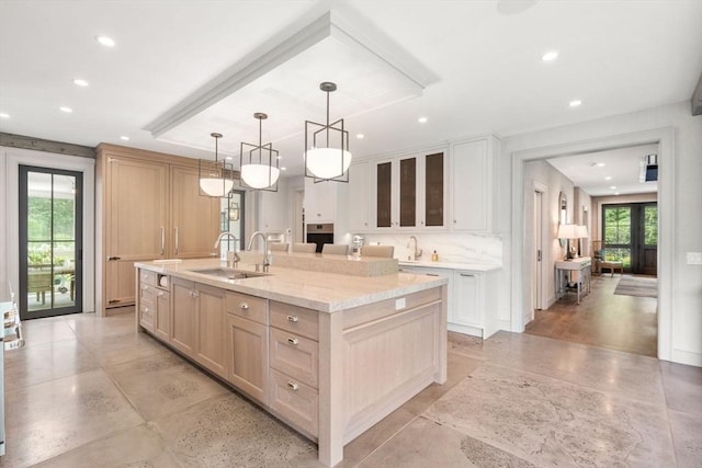 kitchen featuring a healthy amount of sunlight, recessed lighting, and a sink