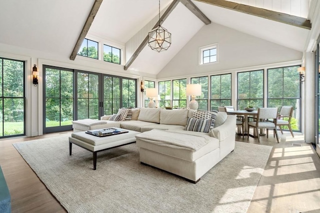 living room featuring wood finished floors, beamed ceiling, and high vaulted ceiling