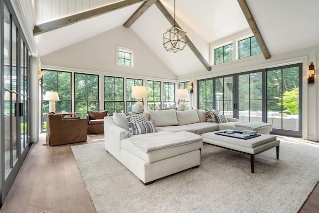 living area featuring wood finished floors, beamed ceiling, and high vaulted ceiling