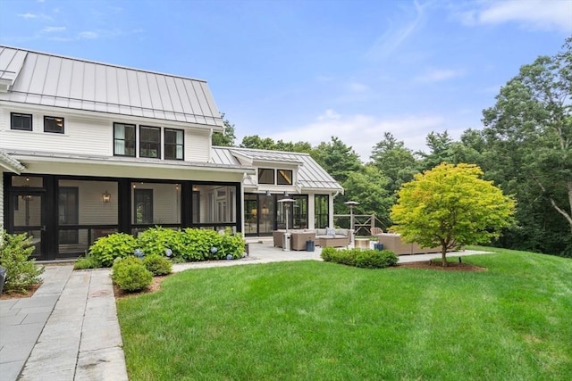 back of house featuring an outdoor hangout area, metal roof, and a standing seam roof