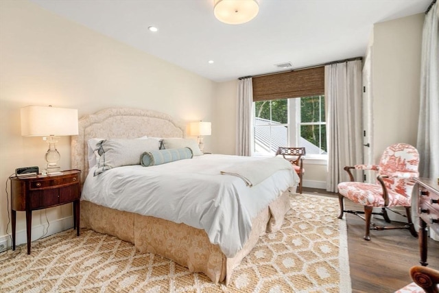 bedroom featuring recessed lighting, baseboards, visible vents, and wood finished floors