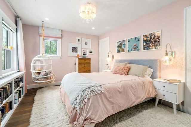bedroom featuring baseboards, a notable chandelier, recessed lighting, and wood finished floors