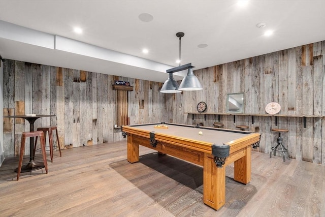playroom with billiards, wood walls, and light wood-style flooring