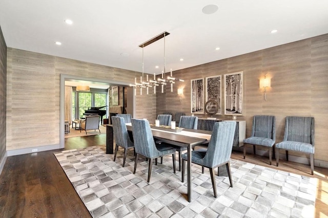 dining room with a chandelier, baseboards, wallpapered walls, and recessed lighting