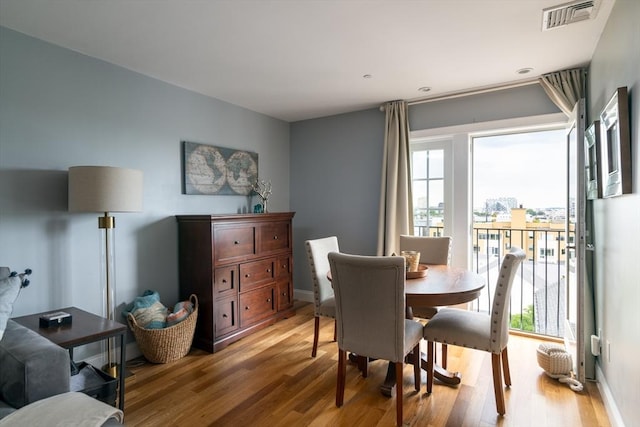 dining area with light wood-style flooring and baseboards