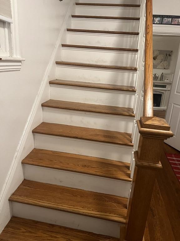 staircase featuring hardwood / wood-style flooring