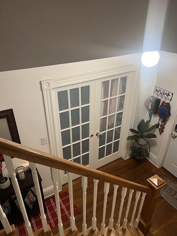 stairway featuring hardwood / wood-style floors and french doors