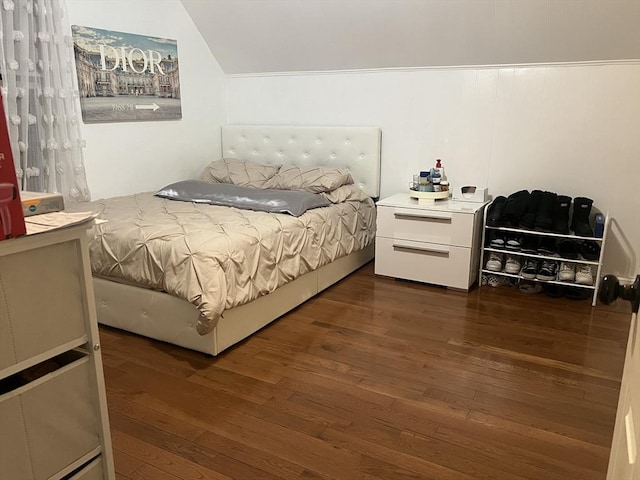 bedroom with lofted ceiling and dark wood-type flooring