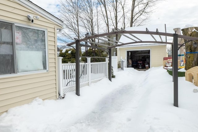 snowy yard with an outdoor structure and fence