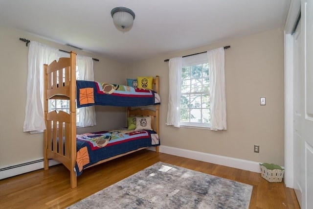 bedroom featuring wood finished floors and baseboards